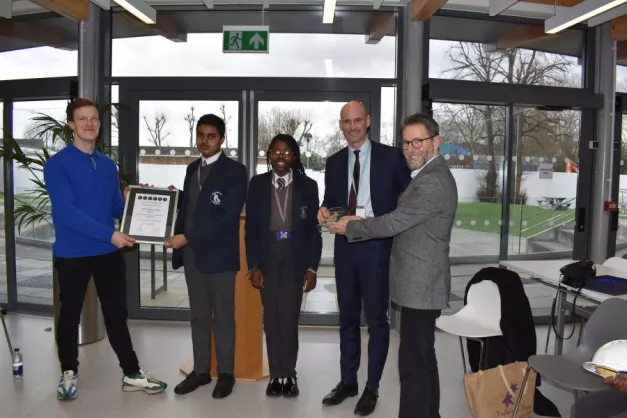 Cllr Strathern and Alex Gee from Evolve hand over the SPACES Award to Sam Jones, Headteacher at Kelmscott and two students