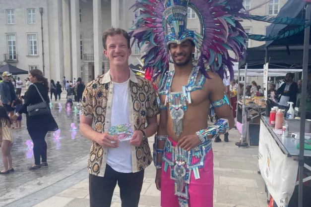 Cllr Alistair Strathern poses for a photo with a member of the carnival troupe 