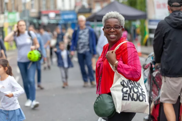 Woman smiling widely at the camera during the Walkinstow event in Walthamstow for World Car Free Day 2019