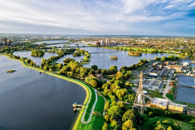 An aerial image of Walthamstow Wetlands with trees and water
