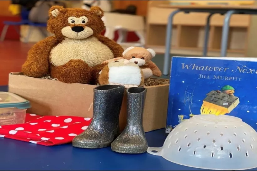 Teddy bear, wellies, sieve and a book