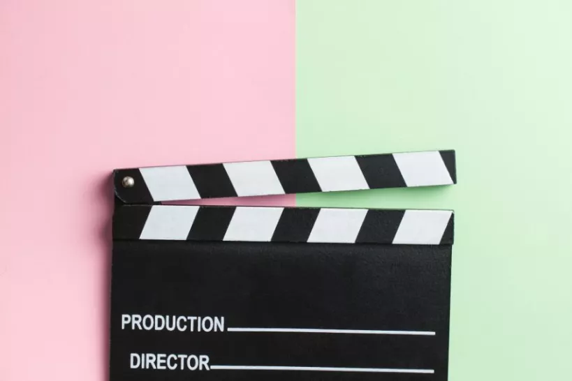 clapper board with pink and green background