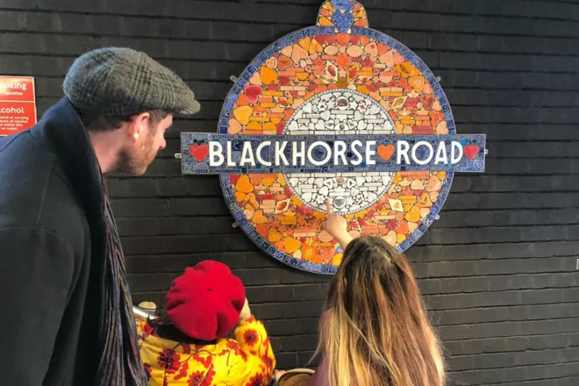 A family point at the Blackhorse Road station roundel artwork