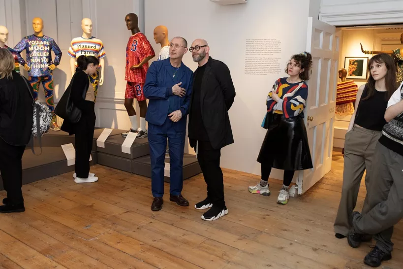 people standing in the the Ashish exhibition with mannequins in the background