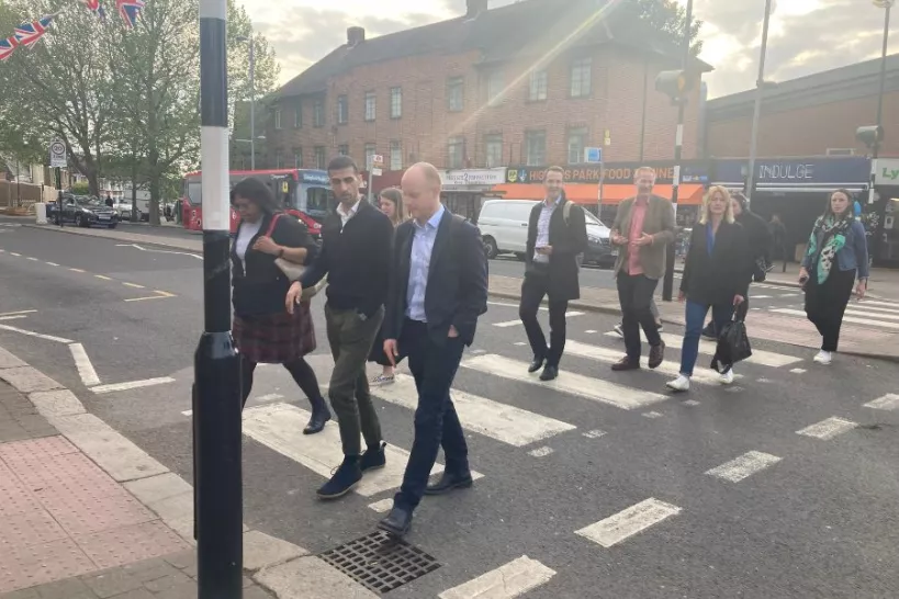Councillors visit Highams Park to view Signal Walk. Councillors and officers are walking across a zebra crossing in Highams Park