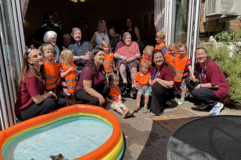 Nursery children pose with care home residents and ducklings