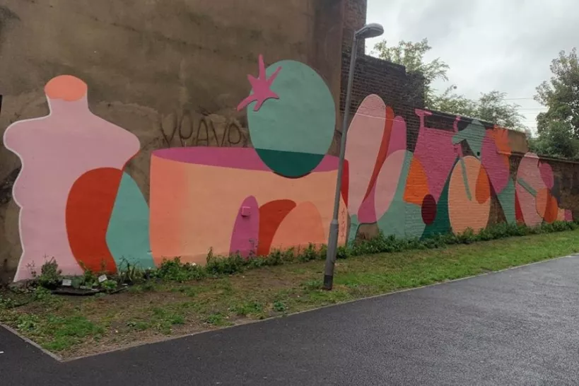 A colourful mural on street wall by Albert Clegg 