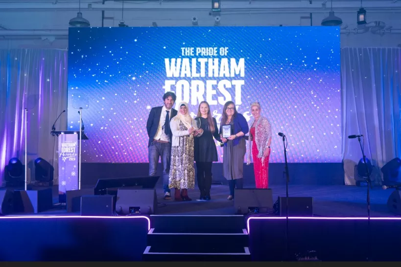 Three members of Waltham Forest Parent Forum on stage with their award, Councillor Ashworth and Mark Watson