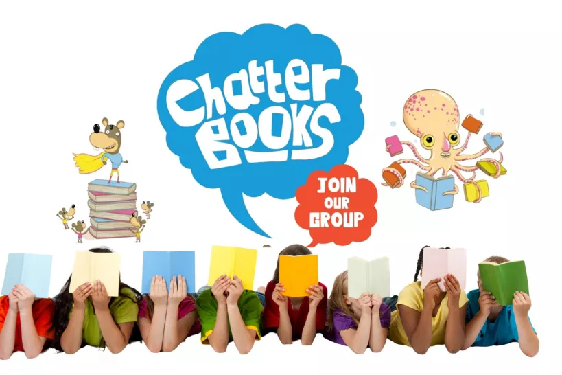 A row of children lying on their fronts reading books with the logo of the Chatterbooks club