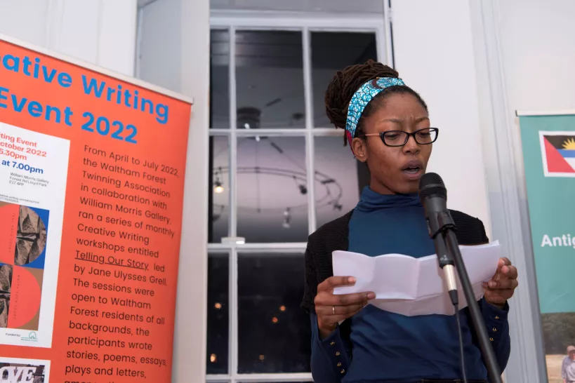 Woman speaks at a creative writing event 
