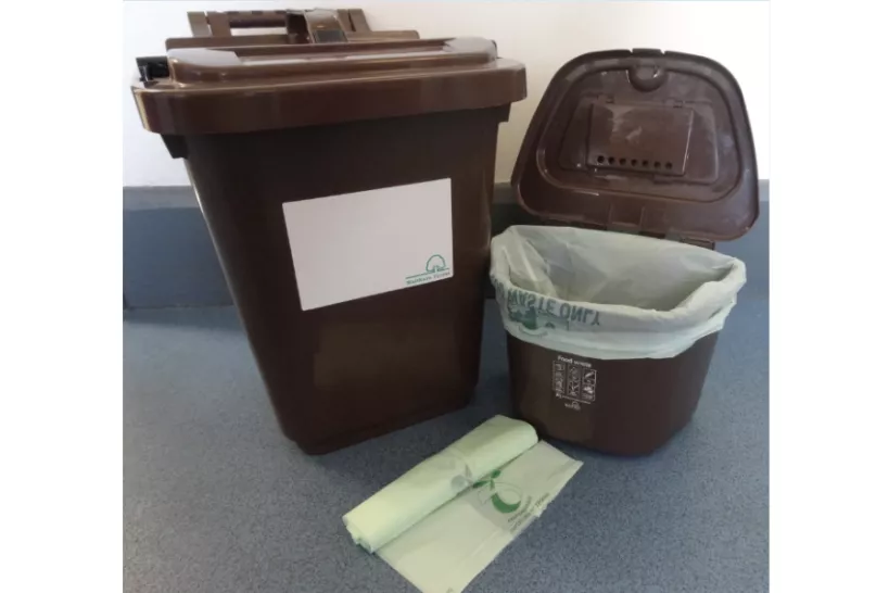 Outdoor food waste bin (left), compostable liners (centre) and kitchen caddy for indoor use (right)